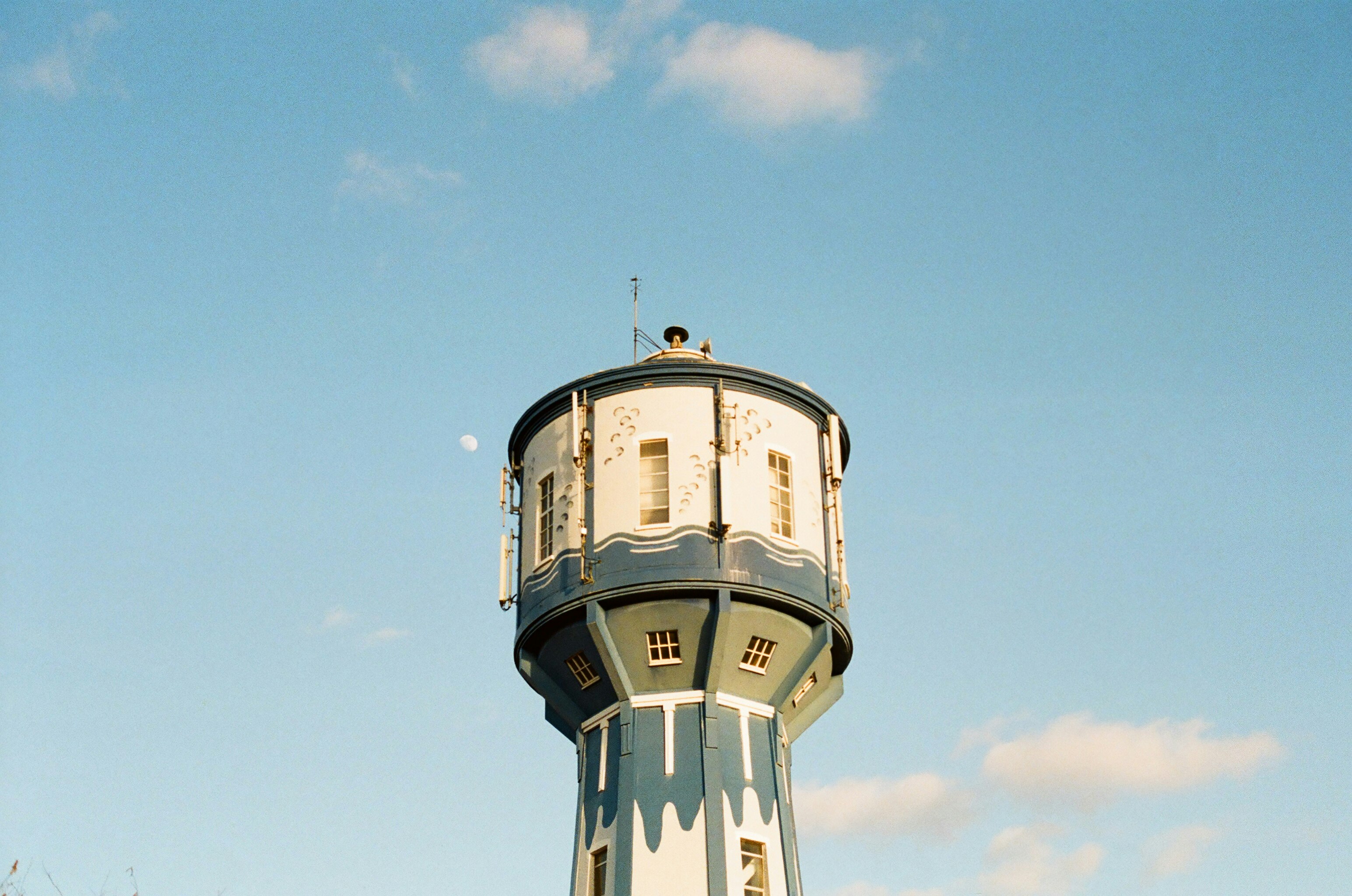 white and brown water tank under blue sky during daytime